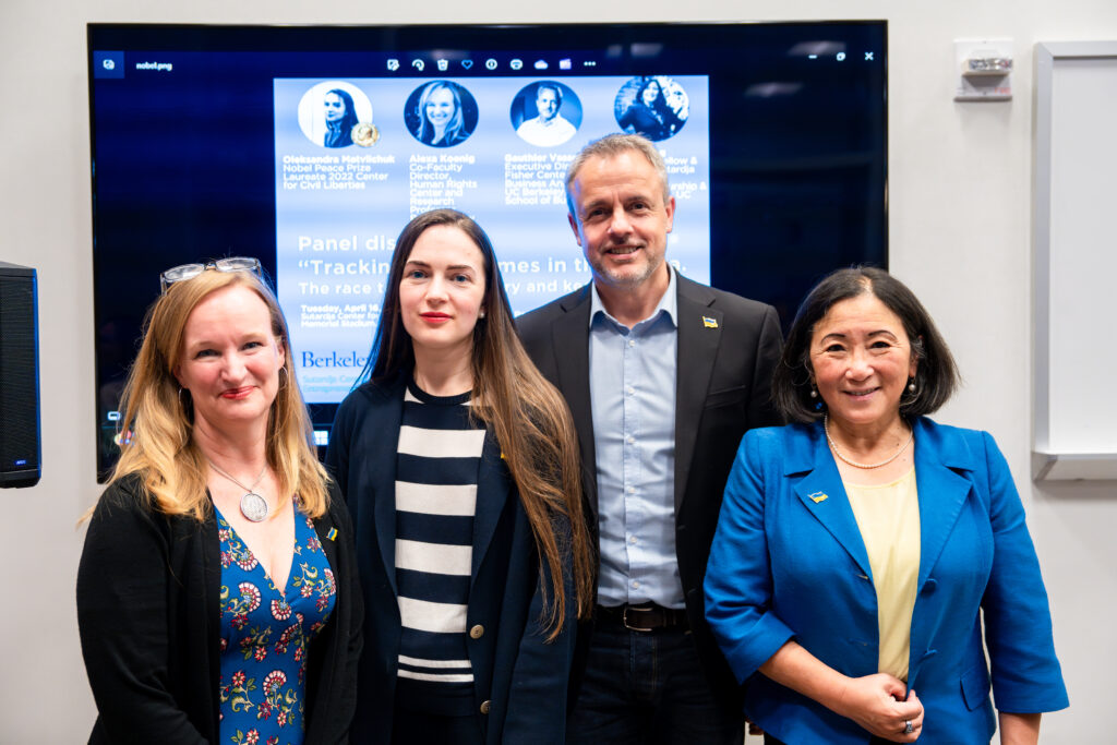 The four panelists pose for a photo together after the discussion on war crimes in the AI Era